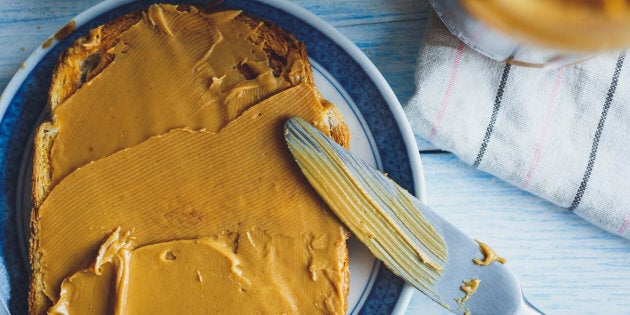 Peanut butter sandwiches or toasts on light wooden background