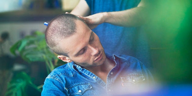 man getting hair cut at barber shop