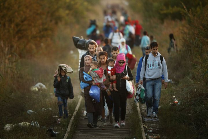 Syrian refugees trek across train tracks, looking for safety (Getty Images/Christopher Furlong)