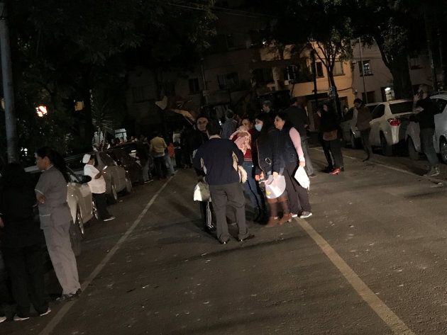 People gather on a street after an earthquake hit Mexico City, Mexico late September 7, 2017.
