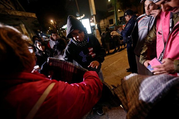 People gather on a street as they receive blankets after an earthquake hit Mexico City, Mexico, September 8, 2017.