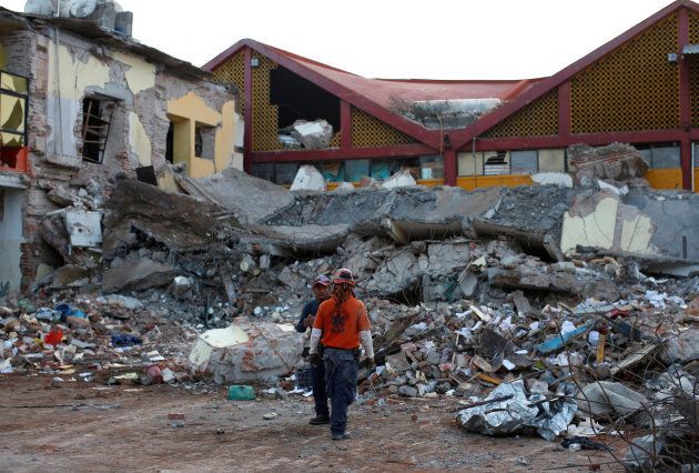 Rescue workers stand in front of the rubbles of a part of the municipal palace in Juchitan, Mexico.