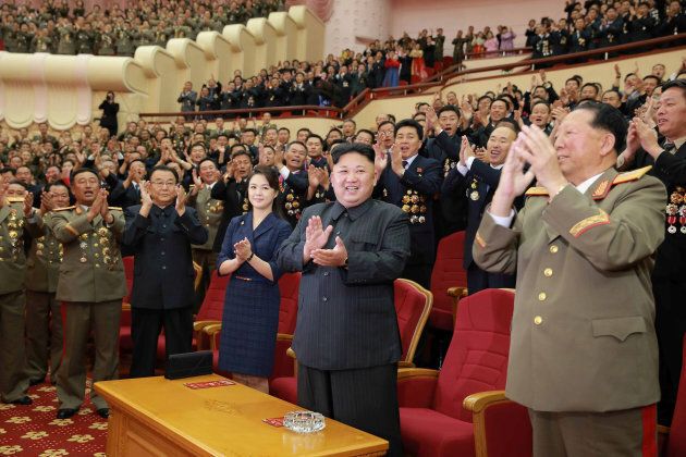 North Korean leader Kim Jong Un claps during a celebration for nuclear scientists and engineers who contributed to a hydrogen bomb test.