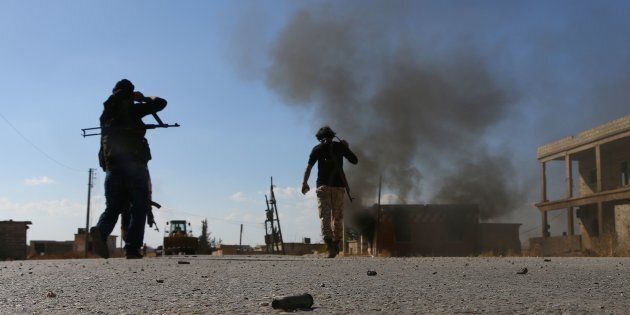 Fighters from the Free Syrian Army fight against the Islamic State (IS) group jihadists on the outskirts of the northern Syrian town of Dabiq, on October 15, 2016.