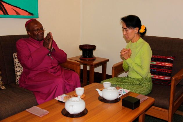 Nobel peace prize laureates, Myanmar's pro-democracy leader Aung San Suu Kyi (R) and South African social rights activist and retired Anglican bishop Desmond Tutu (L) speak at Suu Kyi's house in Yangon, February 26, 2013.
