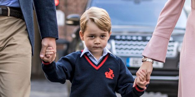 Prince George holding hands with the Duke of Cambridge and Helen Haslem, head of the lower school, at Thomas's Battersea in London, as he starts his first day of school.