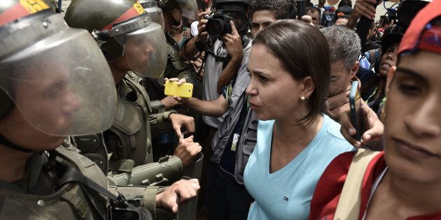 Protesters confront Venezuelan National Police officers during a demonstration for a referendum on the rule of President Nicolás Maduro in Caracas, Venezuela, on May 18, 2016.
