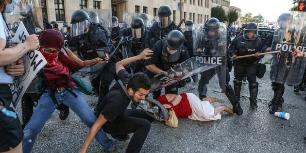 Two police officers were reported hit by bricks.