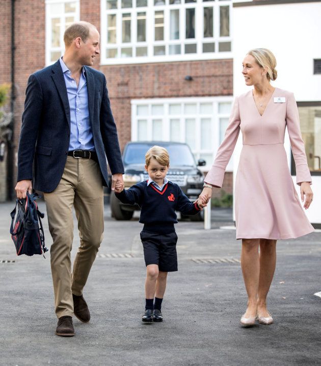 Helen Haslem, head of the lower school and Prince William hold Prince George's hands as he arrives for his first day of school, September 7, 2017. (REUTERS/Richard Pohle/Pool)