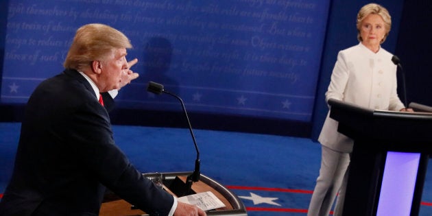 Then-Republican presidential nominee Donald Trump speaks as then-Democratic presidential nominee Hillary Clinton looks on during the final presidential debate on Oct. 19, 2016.