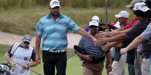 Marc Leishman greets fans during the final round of the BMW Championship at Conway Farms Golf Club in Lake Forest, Illinois.