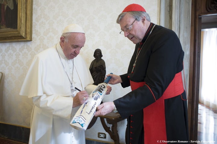 Pope Francis, pictured here signing a cricket bat received from George Pell at the Vatican, is not expected to accept the Cardinal's resignation.