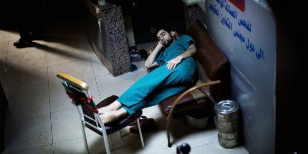 A Syrian doctor sleeps in the waiting room of Dar al-Shifa hospital in Aleppo on Oct. 21, 2012.