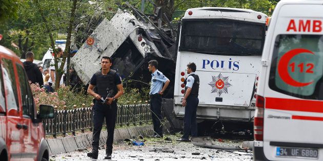 Police walk near a Turkish police bus which was targeted in a bomb attack in a central Istanbul district, Turkey, June 7, 2016. REUTERS/Osman Orsal