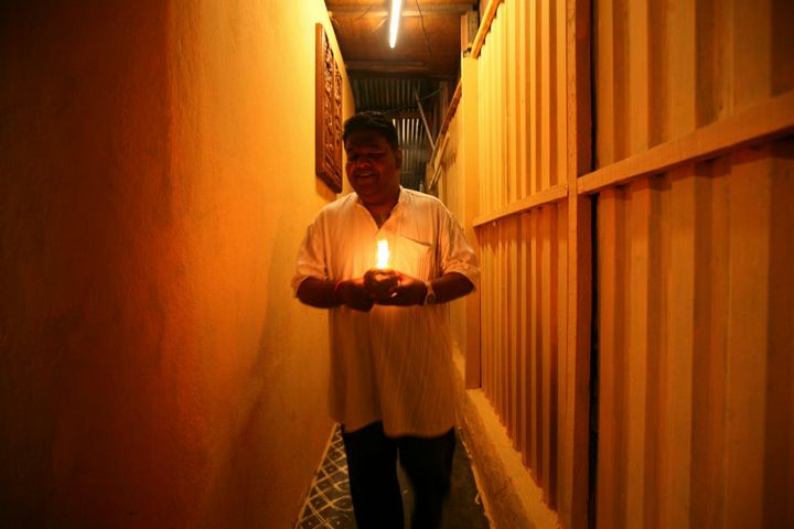 A Hindu man holds an oil lamp while offering prayers ahead of Diwali celebrations in Kuala Lumpur.