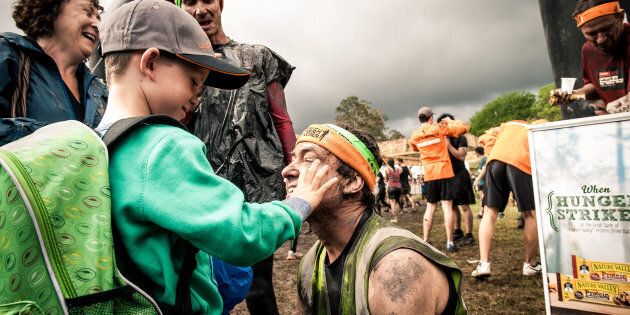 Robin Braidwood and his seven-year-old son Kyte after finishing Tough Mudder. Robin is completely blind.