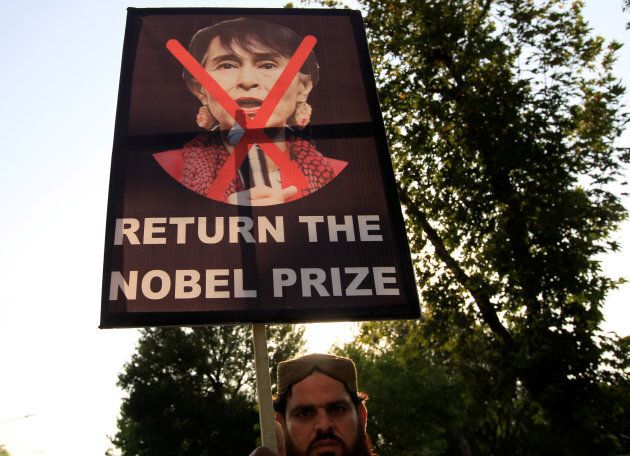 A demonstrator holds a placard during a protest against Myanmar's persecution of Rohingya Muslims in Islamabad, Pakistan.