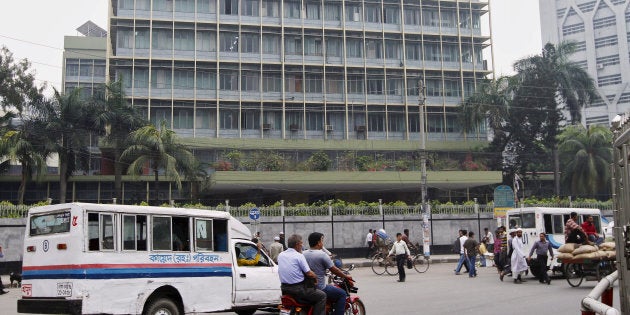 Commuters pass by the front of the Bangladesh central bank building in Dhaka March 8, 2016