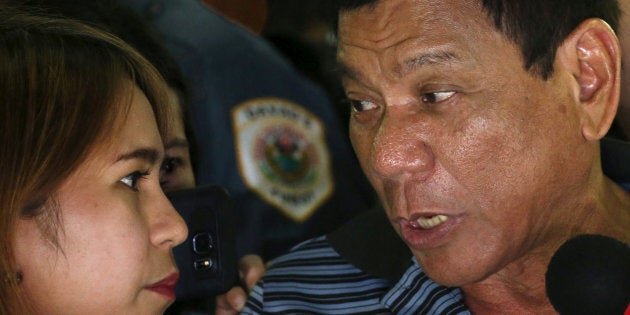 Presidential candidate Rodrigo Duterte talks to a reporter during an election campaigning for May 2016 national elections in Silang, Cavite southwest of Manila, Philippines April 22, 2016. REUTERS/Erik De Castro/File Photo SEARCH ÒDUTERTE PRESIDENCYÓ FOR ALL IMAGES