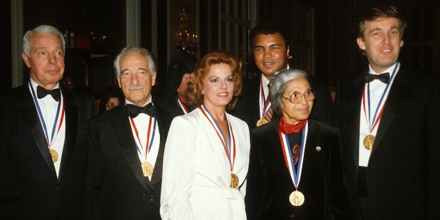 (Left to Right) Joe DiMaggio, Victor Borge, Anita Bryant, Muhammad Ali, Rosa Parks, and Donald Trump pose for a photograph after receiving the Ellis Island Medal of Honor October 27, 1986 in New York City.