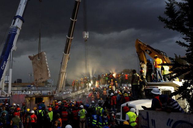 Rescue workers and Mexican soldiers take part in a rescue operation at a collapsed building after an earthquake at the Obrera neighborhood in Mexico City.