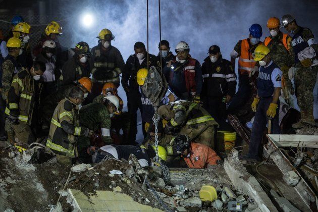 Rescue workers search for trapped citizens after a powerful magnitude 7.1 earthquake.