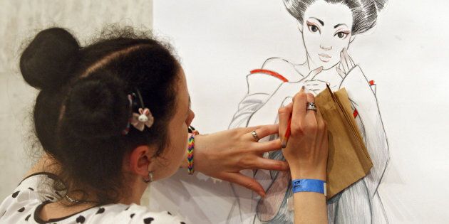 A girl draws during the 'Kyiv Comic Con' festival.