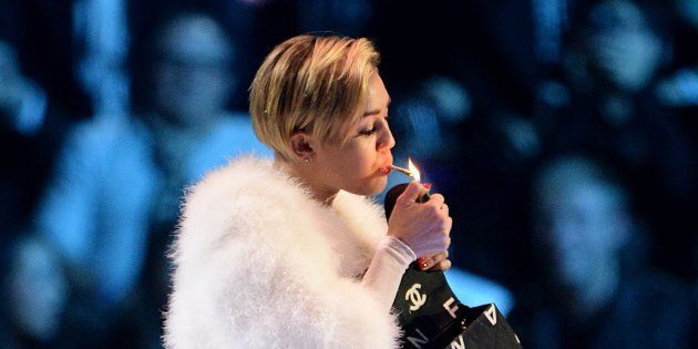 Miley Cyrus smokes on stage during the 2013 MTV Europe Music Awards at the Ziggo Dome Amsterdam, Netherlands.