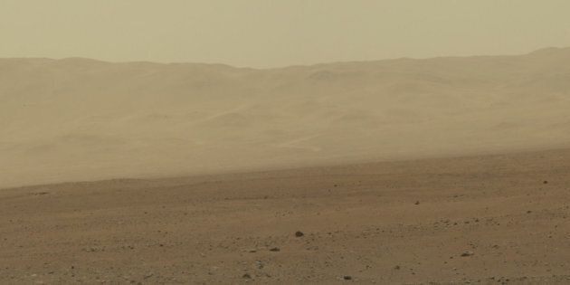 This color image from NASA's Curiosity rover shows part of the wall of Gale Crater, the location on Mars where the rover landed on Aug. 5, 2012 PDT. This area has been known and studied since the 1970s beginning with NASA's Viking missions.