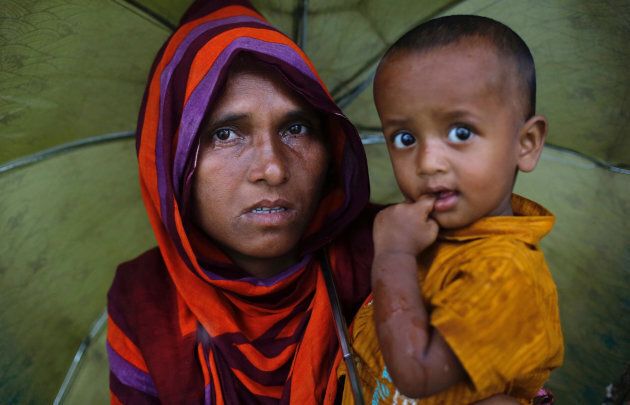 A Rohingya refugee woman cries as she waits for aid at a camp in Cox's Bazar, Bangladesh.