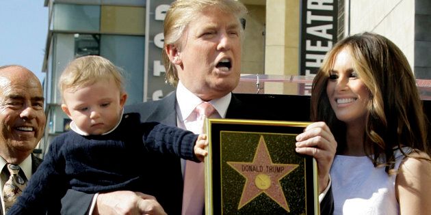 ADVANCE FOR WEDNESDAY, JULY 13, 2016, AT 12:01 A.M. EDT AND THEREAFTER - FILE - In this Jan. 16, 2007 file photo, Donald Trump, with his wife, Melania Trump, and their son, Barron, pose for a photo after he was honored with a star on the Hollywood Walk of Fame in Los Angeles. (AP Photo/Damian Dovarganes, File)