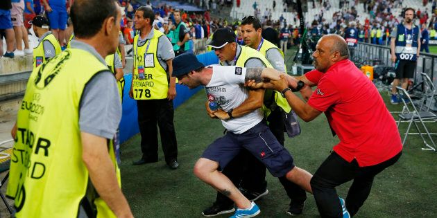 Football Soccer - England v Russia - EURO 2016 - Group B - Stade V?lodrome, Marseille, France - 11/6/16A fan is restrained by security after the gameREUTERS/Yves HermanLivepic