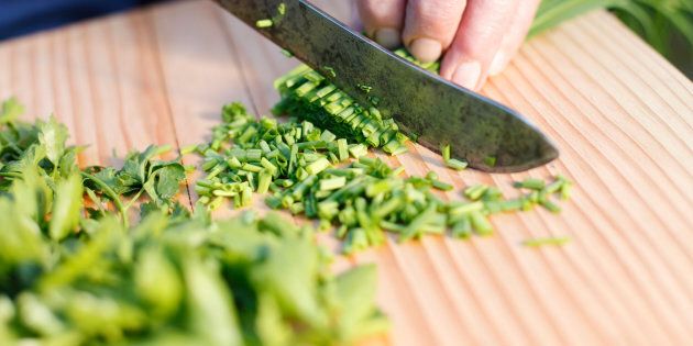 old woman cuts chives