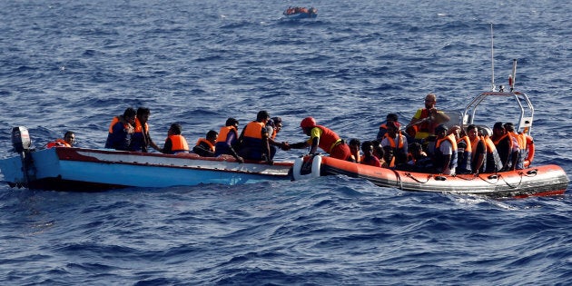 An inflatable boat from the Spanish vessel Astral operated by the NGO Proactiva collects migrants off the Libyan coast in the Mediterranean Sea August 18, 2016. REUTERS/Giorgos Moutafis