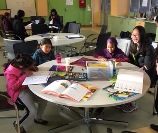 A high school student helping out at Homework Club