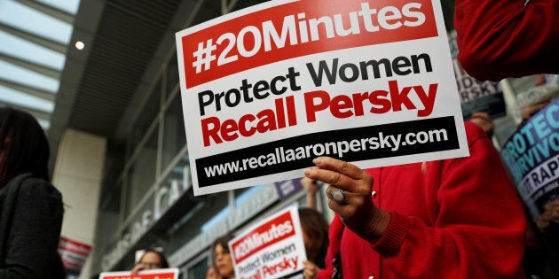 Activists hold signs calling for the removal of Judge Aaron Persky from the bench after his controversial sentencing in the Stanford rape case, in San Francisco, California, U.S. June 10, 2016. REUTERS/Stephen Lam