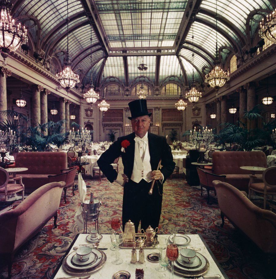Journalist Lucius Beebe in the glass roofed Garden Court of the Palace Hotel, San Francisco.