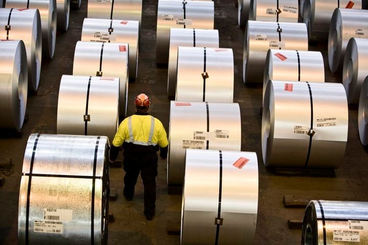 A worker walks among the steel coils produced at Port Kembla