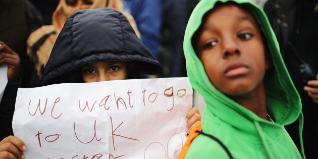 CALAIS, FRANCE - OCTOBER 26: Women and children protest their case to the UK goverment at the notorious Jungle camp as migrants leave and the authorities demolish the site on October 26, 2016 in Calais, France. Overnight fires broke out in many parts of the camp destroying shacks and makeshift shops along the camps main street. Many migrants have left by coach to be reloctated at centres across France. (Photo by Christopher Furlong/Getty Images)