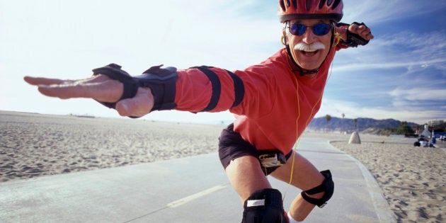 Senior man in-line skating in a surfing pose