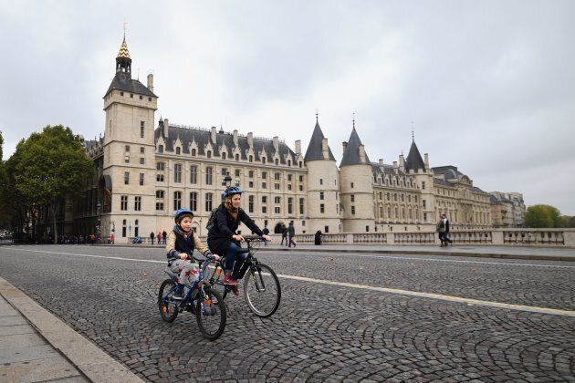 A cyclist rides past the 'Conciergerie', a former prison and royal palace.
