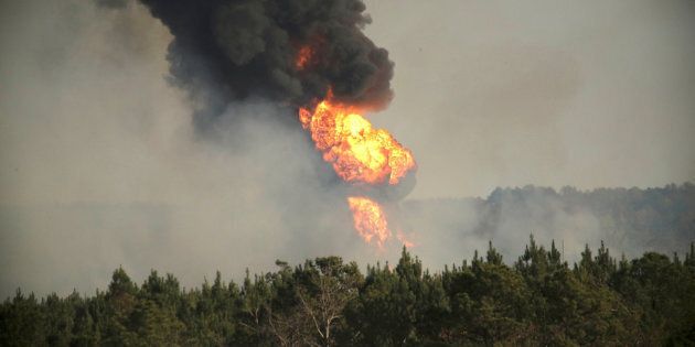 Flames shoot into the sky from a gas line explosion in western Shelby County, Alabama, on Monday.