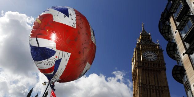 The design of a British Union Flag, also known as Union Jack, sits on a balloon filled with helium floating near the Houses of Parliament in London, U.K., on Wednesday, June 15, 2016. The campaigns for and against keeping the U.K. in the European Union laid out opposing visions of life outside the bloc as dueling ahead of next week's referendum enters its final stretch. Photographer: Luke MacGregor/Bloomberg via Getty Images