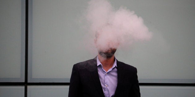 A man vapes outside Southwark Crown Court in London, Britain, September 25, 2017.