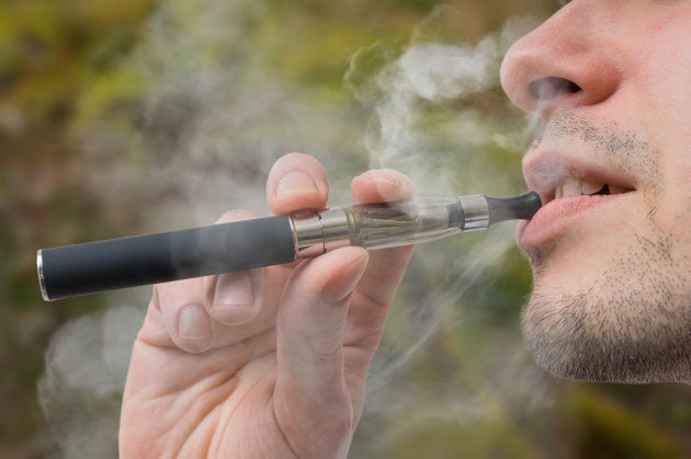 A young smoker inhales on an e-cigarette, or 'vape.'