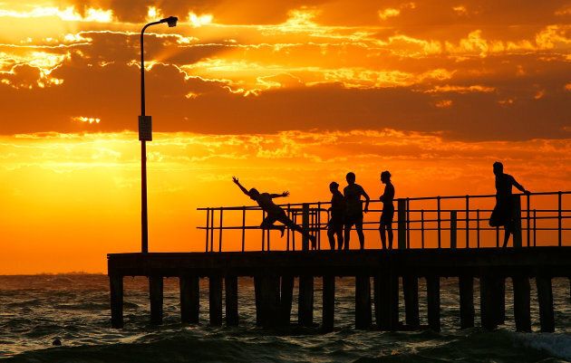 People dive into the sea from the pier at St Kilda beach on January 30, 2009 in Melbourne during a heatwave.