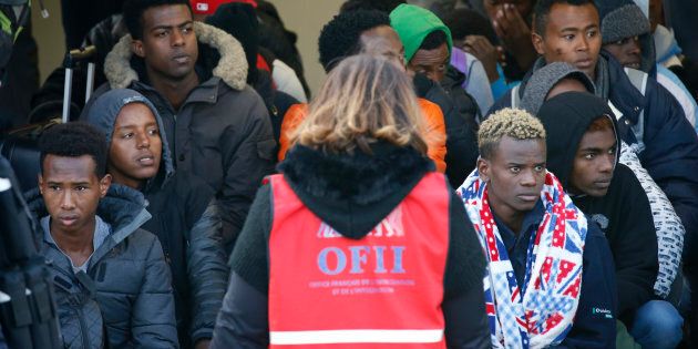 Migrant minors queue to take a bus before their transfer by French authorities to reception centres across the country at the end of the dismantlement of the camp called the