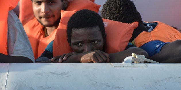 Men wait on a rubber boat to be rescued by the crew of the Topaz Responder ship run by Maltese NGO Moas and the Italian Red Cross during a rescue operation of Migrants and refugees on November 3, 2016, off the Libyan coast in the Mediterranean Sea. / AFP / ANDREAS SOLARO (Photo credit should read ANDREAS SOLARO/AFP/Getty Images)