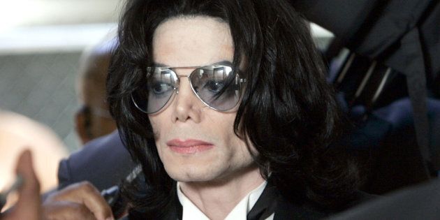 SANTA MARIA, CA - JUNE 13: Michael Jackson prepares to enter the Santa Barbara County Superior Court to hear the verdict read in his child molestation case June 13, 2005 in Santa Maria, California. After seven days of deliberation the jury has reached a not guilty verdict on all 10 counts in the trial against Michael Jackson. Jackson was charged in a 10-count indictment with molesting a boy, plying him with liquor and conspiring to commit child abduction, false imprisonment and extortion. He pleaded innocent. (Photo by Kevork Djansezian-Pool/Getty Images)