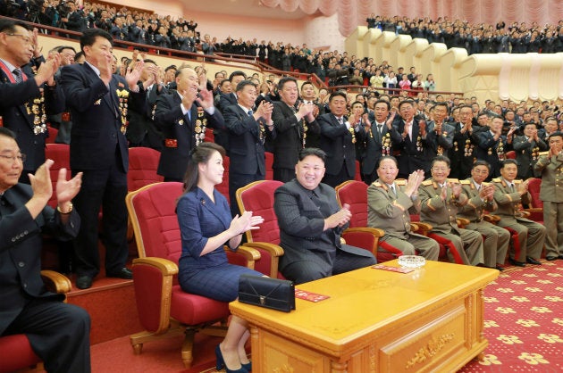 North Korean leader Kim Jong Un claps during a celebration for nuclear scientists and engineers.